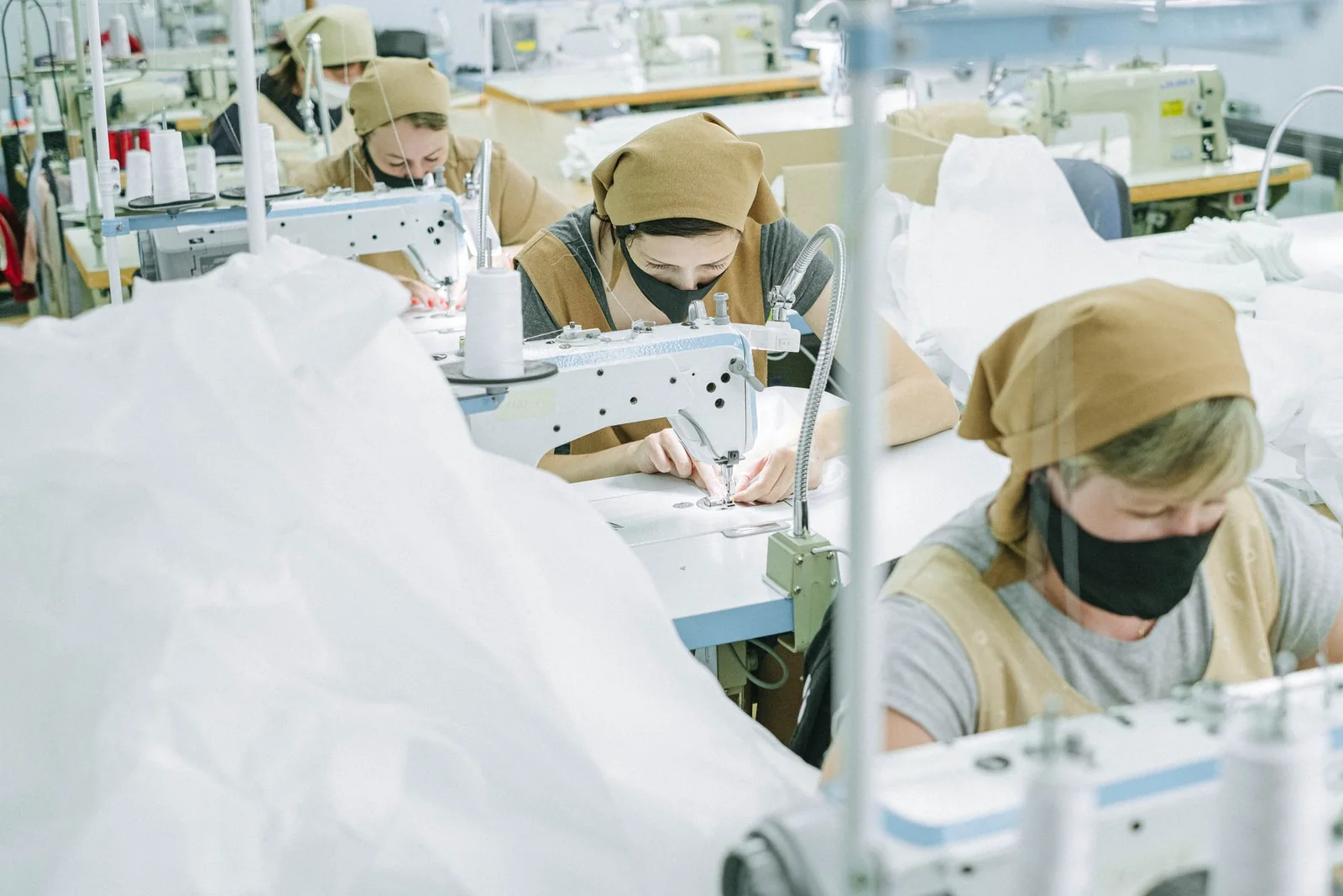 Sewing work in a textile workshop, shown as illustrative category photography